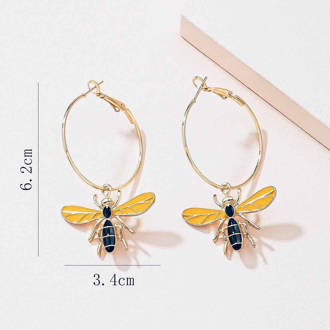 Bee charms on hoop in gold tone